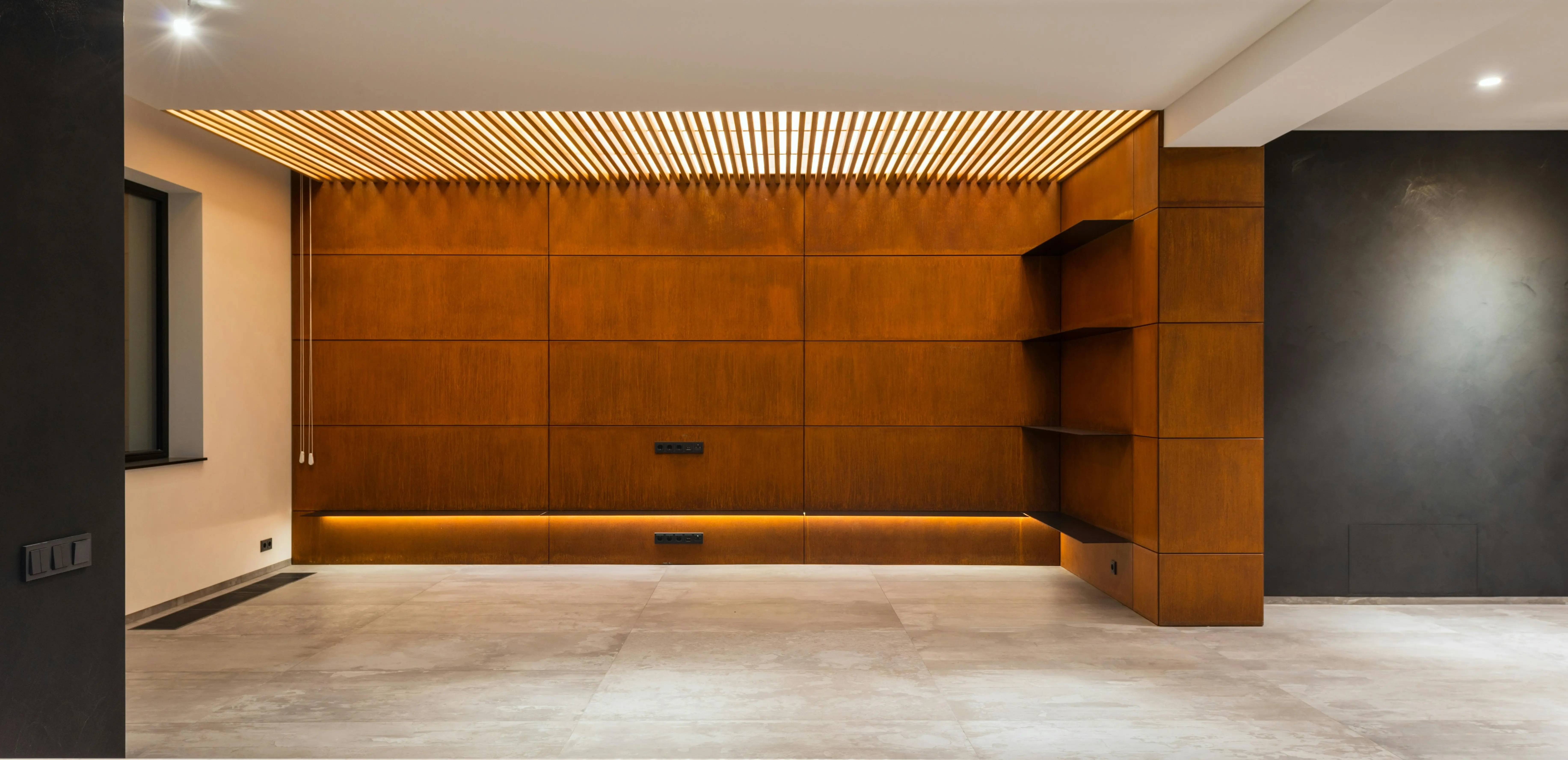 Luxury residential great room with architectural ceiling lighting and full-height motorized shades managing the long view